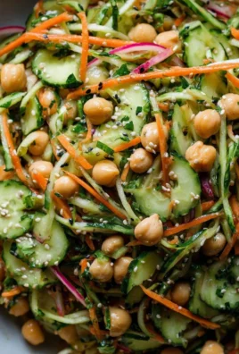 Asian cucumber slaw with chickpeas and sesame dressing in a bowl