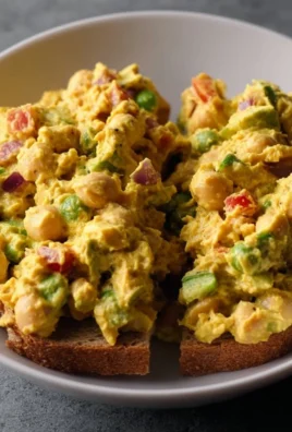 Delicious curried chickpea salad with vibrant vegetables and spices.