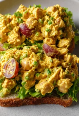 Bowl of best curried chickpea salad with fresh vegetables and spices