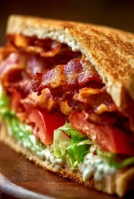 Delicious BLT sandwich with bacon, lettuce, and tomatoes on a plate