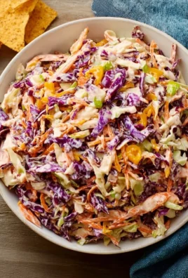 A vibrant bowl of bold coleslaw featuring colorful vegetables and dressing