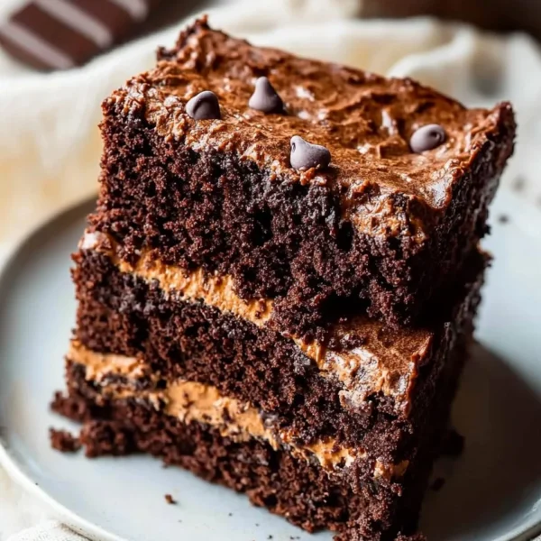 Delicious homemade brownie cake topped with chocolate frosting and sprinkles.