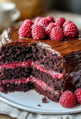 Delicious slice of Chocolate Raspberry Cake with vibrant raspberry topping
