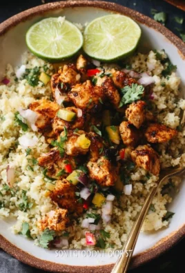 Cilantro lime chicken served with riced cauliflower on a plate.