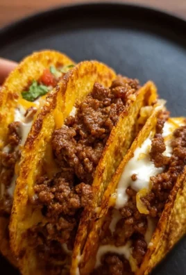 Delicious crispy ground beef tacos served with toppings