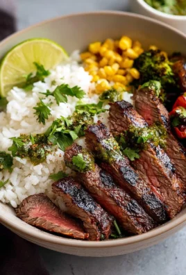 A flavorful flank steak bowl topped with fresh vegetables and spices.
