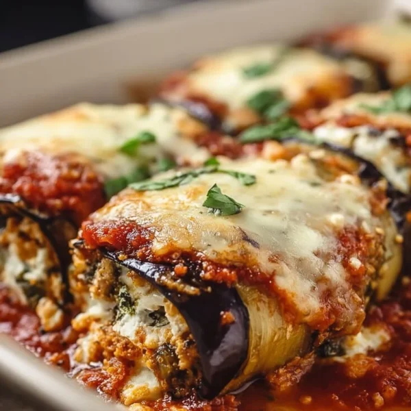 Fluffy eggplant rollatini bake topped with marinara sauce and cheese
