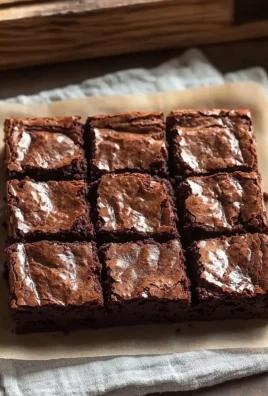 Delicious fudgy brownies topped with chocolate chips on a white plate