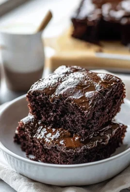 Delicious Hot Fudge Cake drizzled with chocolate sauce and topped with whipped cream.