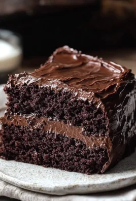 Delicious slice of Ina Garten's chocolate fudge cake topped with chocolate ganache.