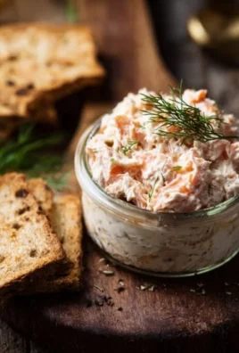 Ina Garten's smoked salmon spread served in a bowl with fresh herbs