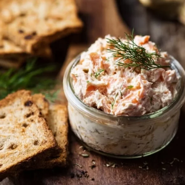 Ina Garten's smoked salmon spread served in a bowl with fresh herbs