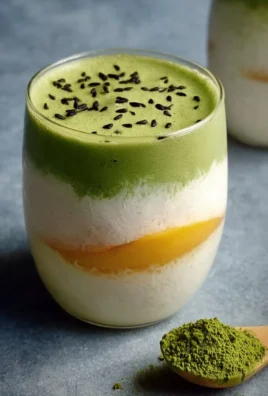 Delicious Mango Sticky Rice Matcha Latte served in a glass with colorful toppings