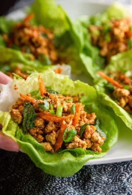 Plate of Low Carb Thai Chicken Lettuce Wraps with fresh vegetables and sauce