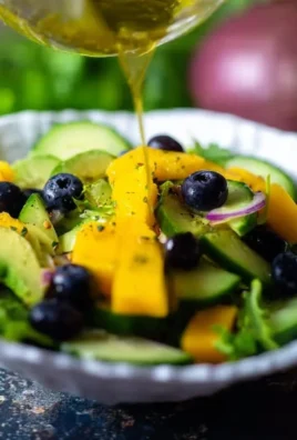 Mango Cucumber Salad with Blueberries and Avocado on a white plate