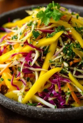 A colorful bowl of Mango Slaw with fresh mango, veggies, and a zesty dressing.
