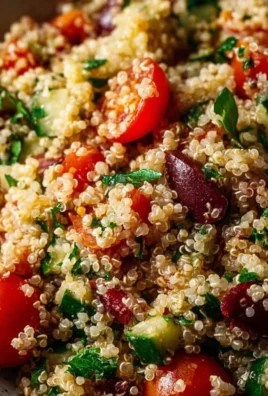 Colorful Mediterranean Quinoa Salad with vegetables and herbs in a bowl.
