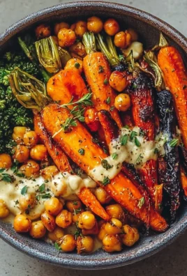 One-pan roasted carrot and chickpea bowl garnished with fresh herbs.