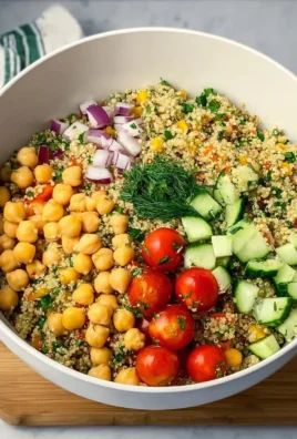 Bowl of Quinoa Chickpea Salad with fresh vegetables and herbs