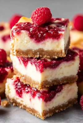 Delicious Raspberry Cheesecake Bars topped with fresh raspberries