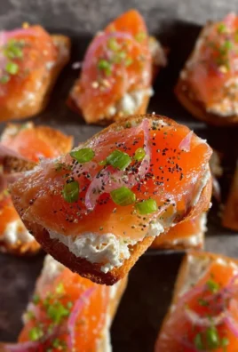 Delicious smoked salmon crostini topped with cream cheese and herbs