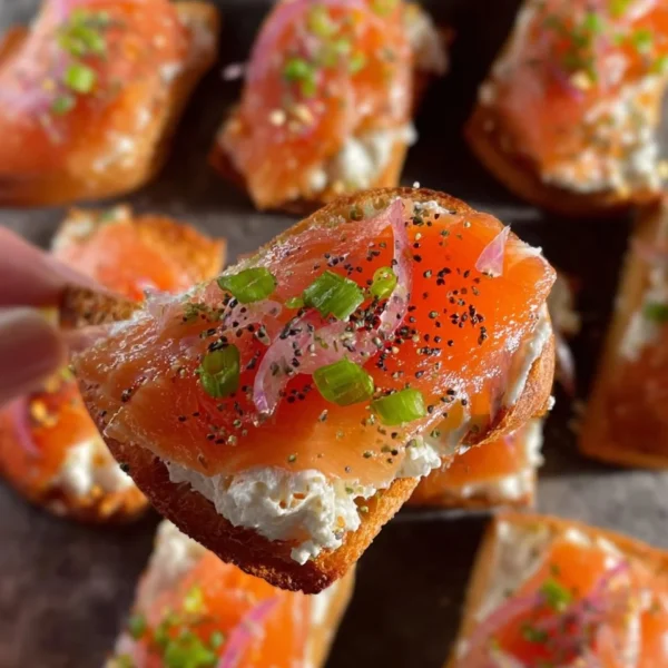 Delicious smoked salmon crostini topped with cream cheese and herbs
