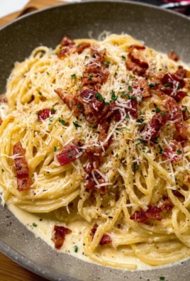 Creamy spaghetti carbonara served with fresh parsley and grated cheese