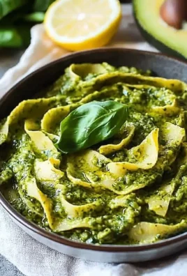 Nut-free Avocado Lemon Pesto served in a bowl with fresh ingredients