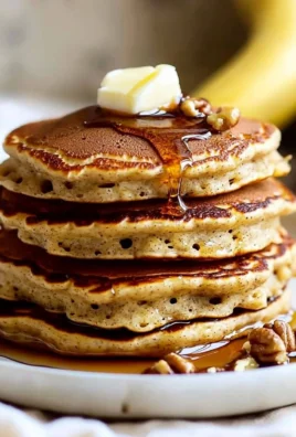 Delicious banana bread pancakes served with syrup and bananas on top