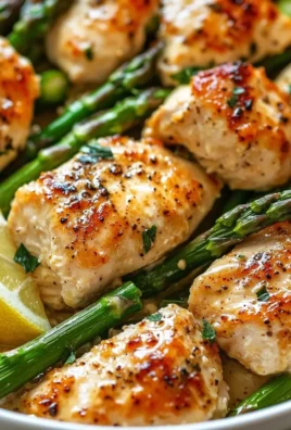Caesar Chicken with Asparagus served on a plate, garnished with herbs