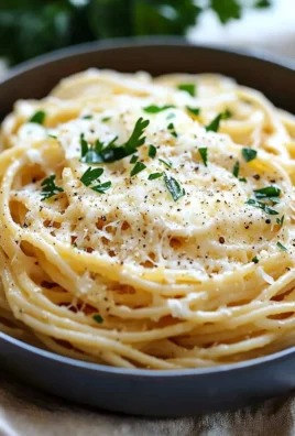 Delicious garlic parmesan spaghetti topped with cheese and fresh herbs