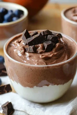 Delicious chocolate protein pudding in a bowl topped with chocolate shavings