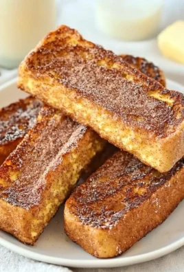 Cinnamon French Toast Sticks served with syrup and fresh fruit