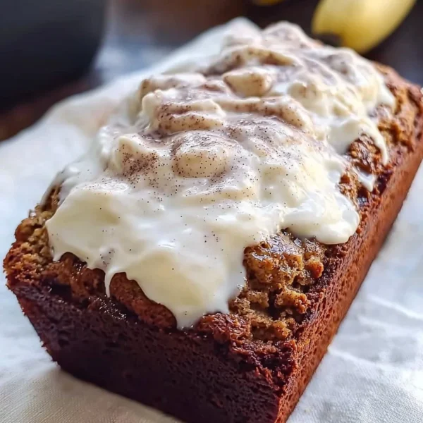 Freshly baked Cinnamon Roll Banana Bread with cinnamon swirl topping