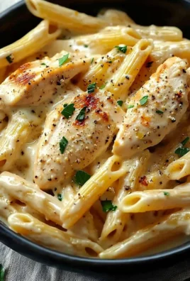 Delicious bowl of Crac Chicken Penne with creamy sauce and fresh ingredients