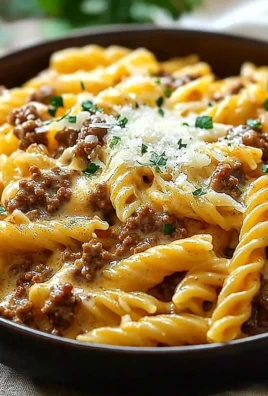 Creamy high protein beef pasta dish garnished with herbs