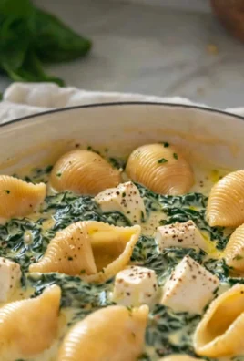Creamy spinach tofu shells served on a plate with fresh herbs