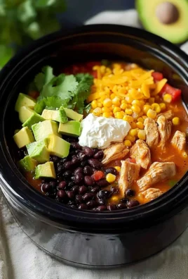 Crock Pot Fiesta Chicken topped with fresh herbs and served with rice