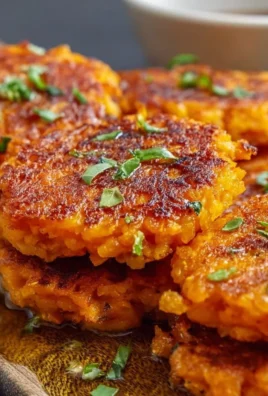 Healthy Sweet Potato Hash Browns served on a plate with fresh herbs.