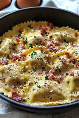 Ravioli in creamy carbonara sauce, garnished with parsley and parmesan cheese.