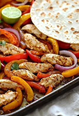 Sheet pan chicken fajitas with colorful bell peppers and spices.