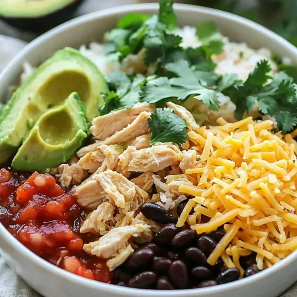 Slow cooker chicken burrito bowl with rice, beans, and fresh toppings