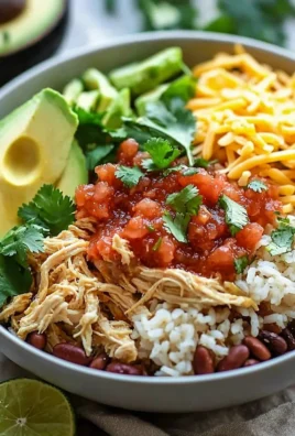 Delicious slow cooker chicken burrito bowl topped with fresh ingredients.