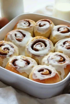 Delicious homemade cinnamon rolls topped with cream cheese frosting.