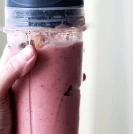 Quick 2-ingredient frozen fruit smoothie in a glass with fresh fruit.