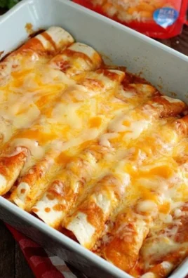 Delicious 5 ingredient beef enchiladas topped with cheese and garnished