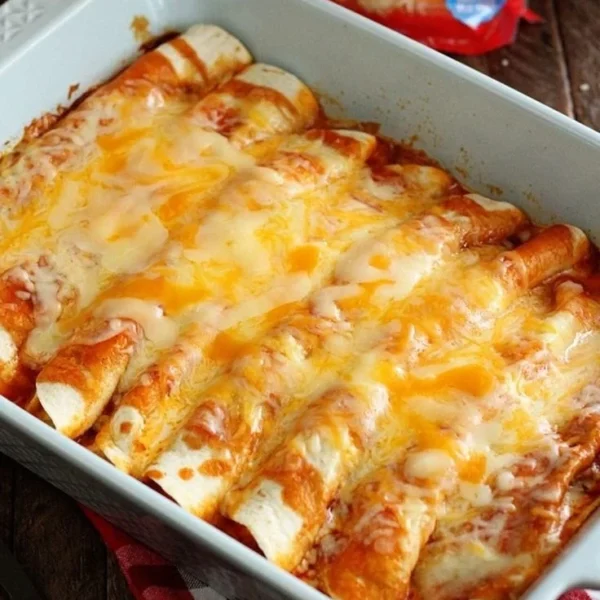 Delicious 5 ingredient beef enchiladas topped with cheese and garnished