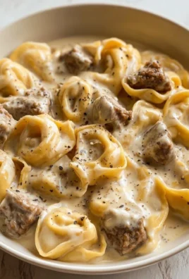 Creamy Beef Stroganoff served with tortellini on a plate