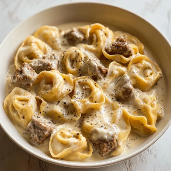 Creamy Beef Stroganoff served with tortellini on a plate