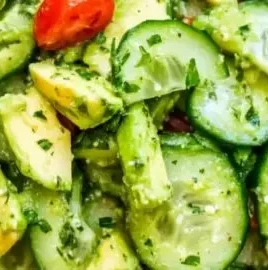 Fresh avocado cucumber salad with herbs and lime dressing